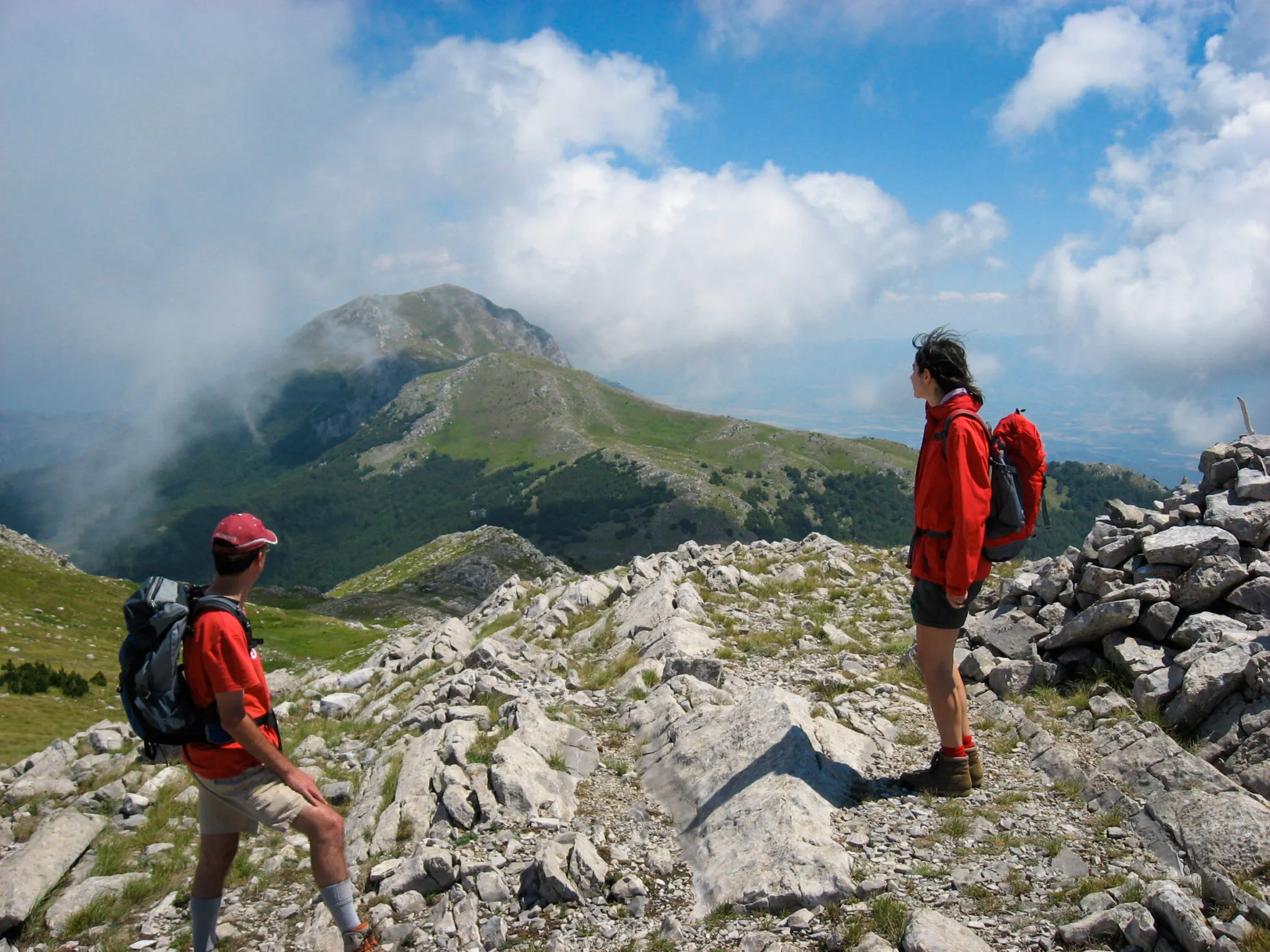 Two hikers atop a mountain