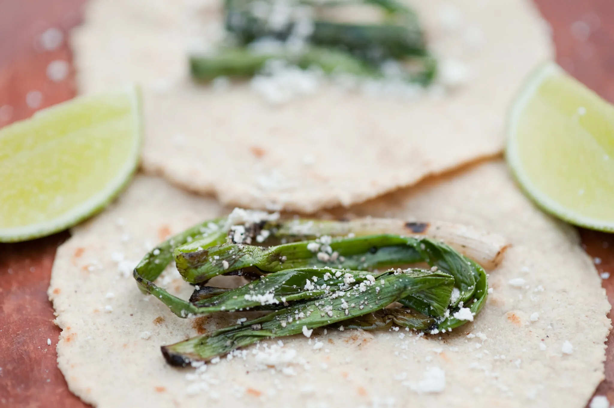 Closeup of tortilla, onions and limes