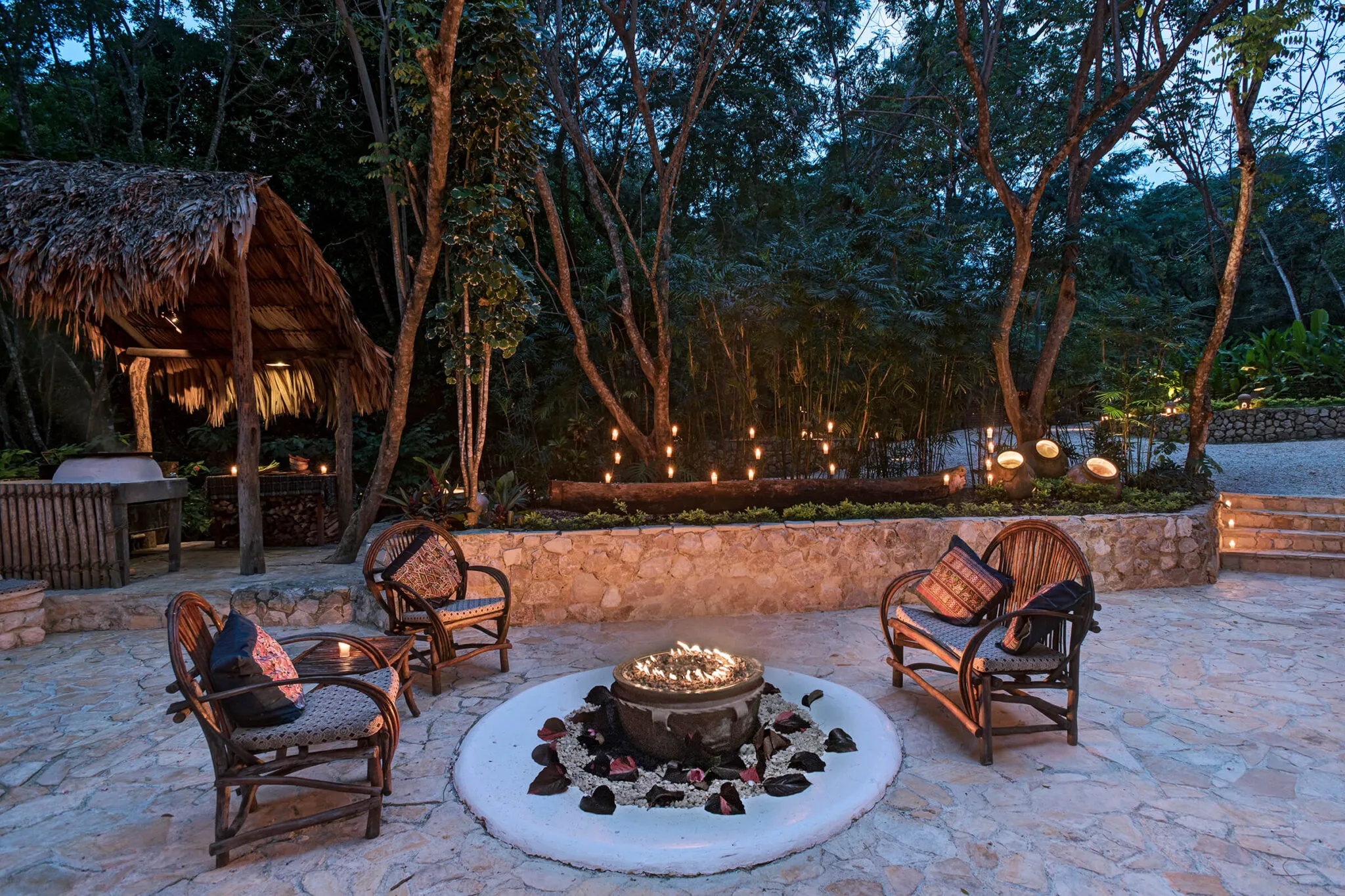 Three lounge chairs surround a firepit at the restaurant at La Lancha.