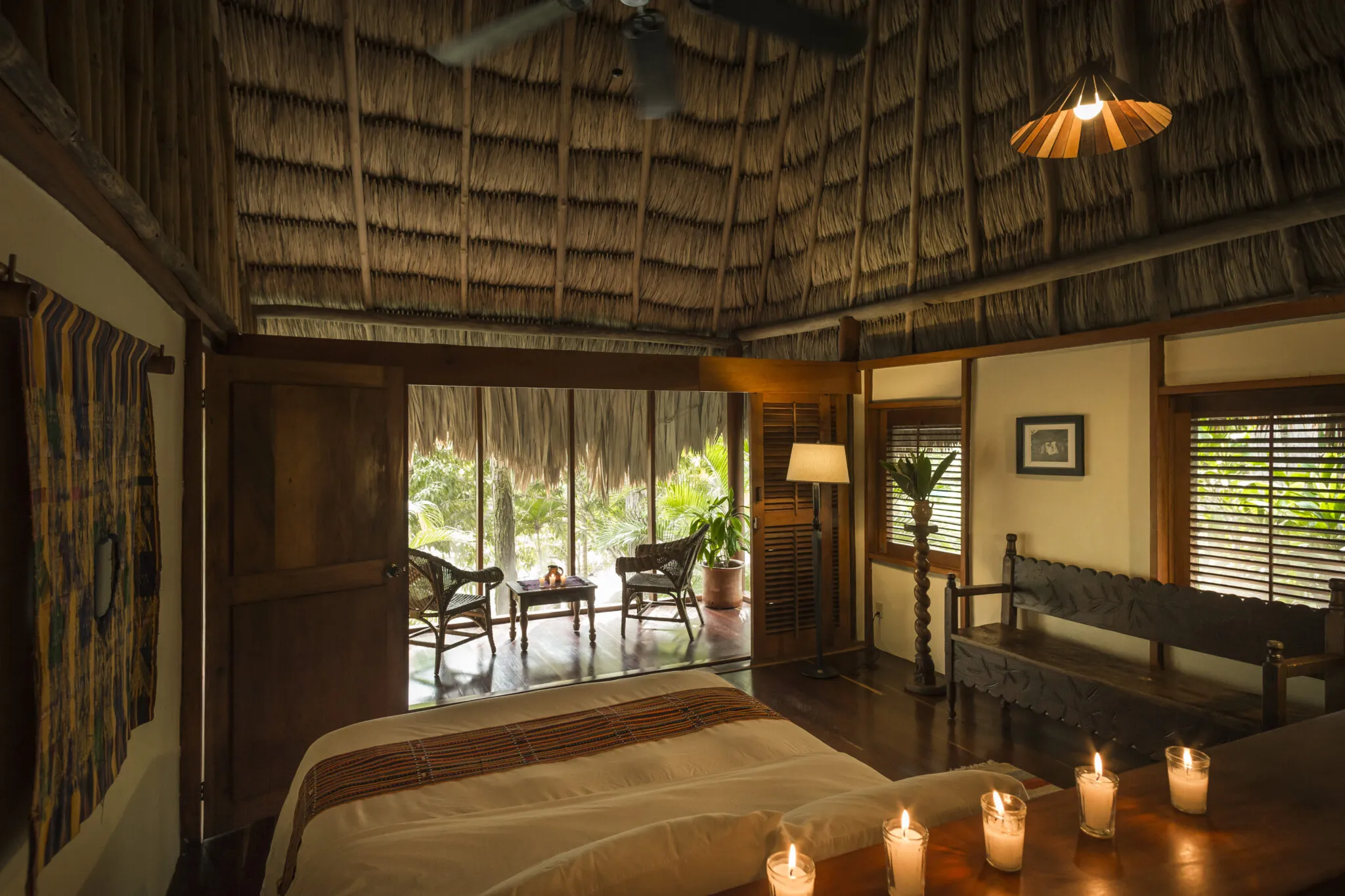 Cabana interior including a double bed and screened in porch