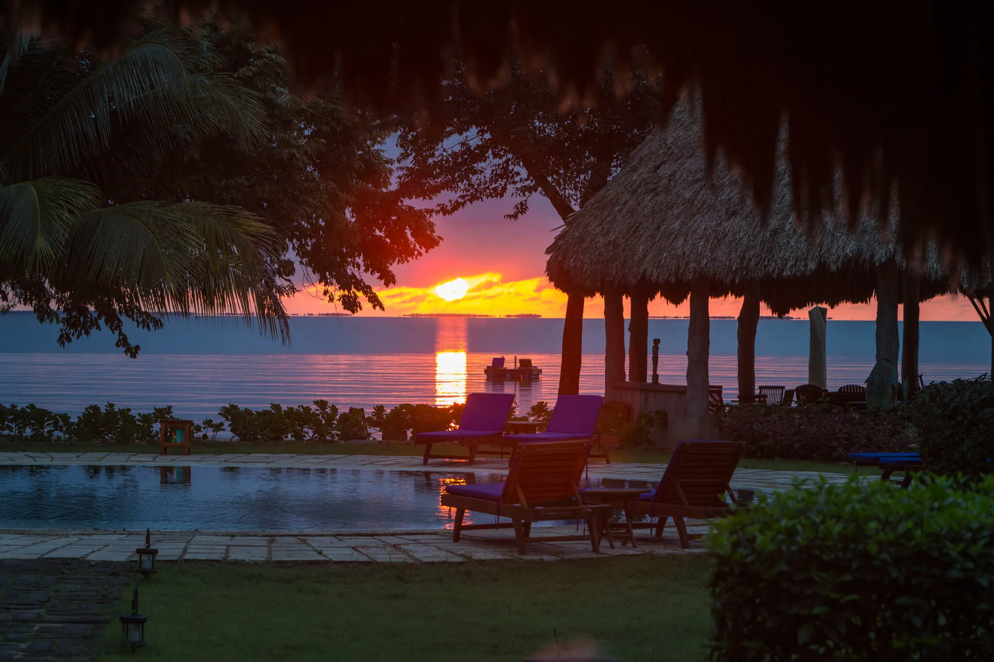 Looking at the ocean from a pool deck at sunset