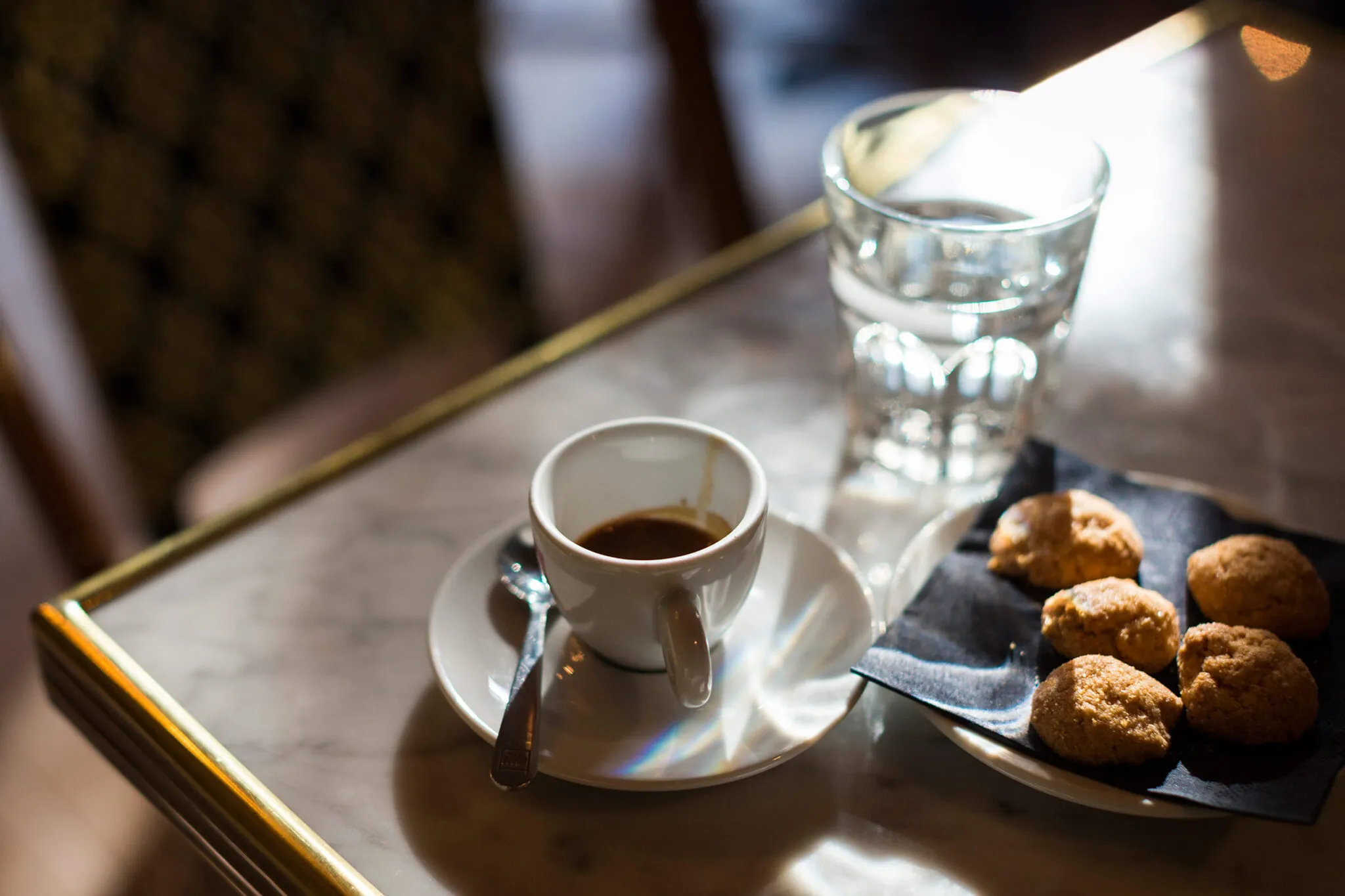 Close up of espresso cup and plate of pastries