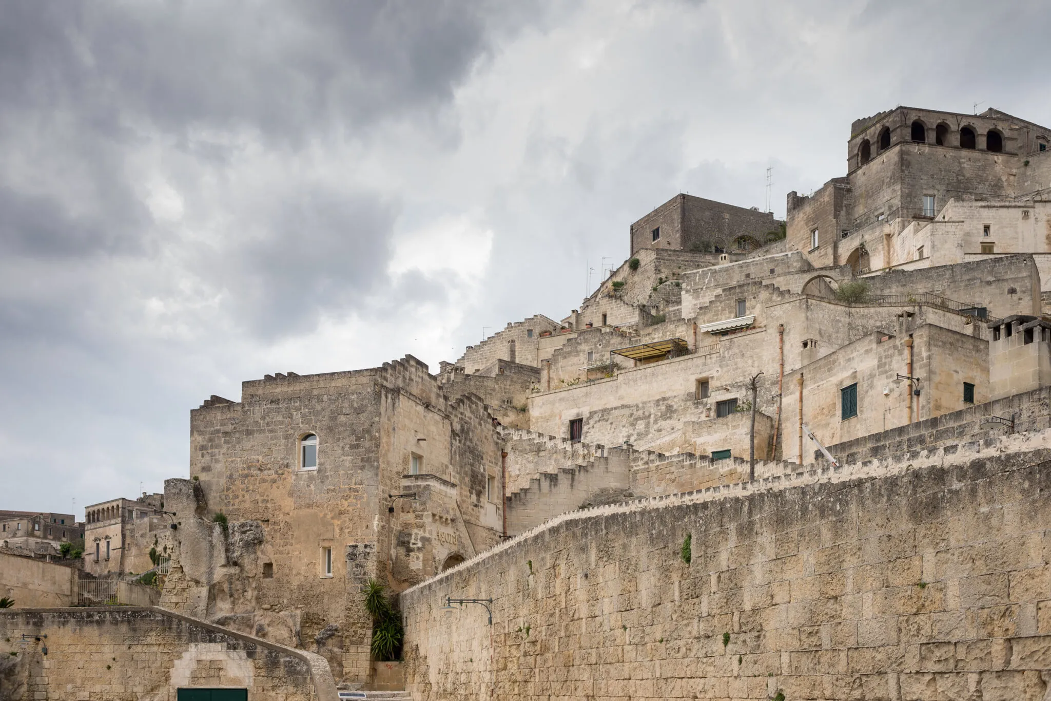 Looking up at a stone building on the Matera hillside