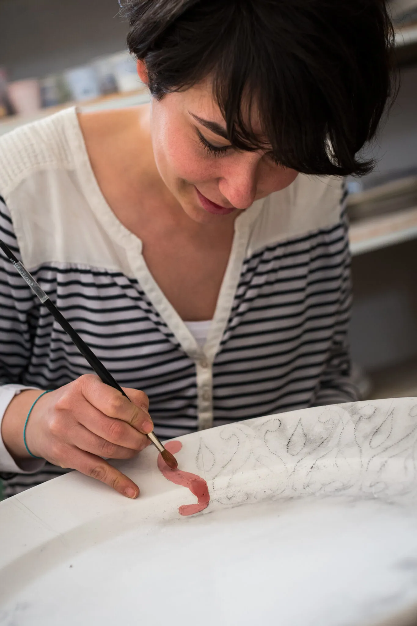 Woman painting ceramics