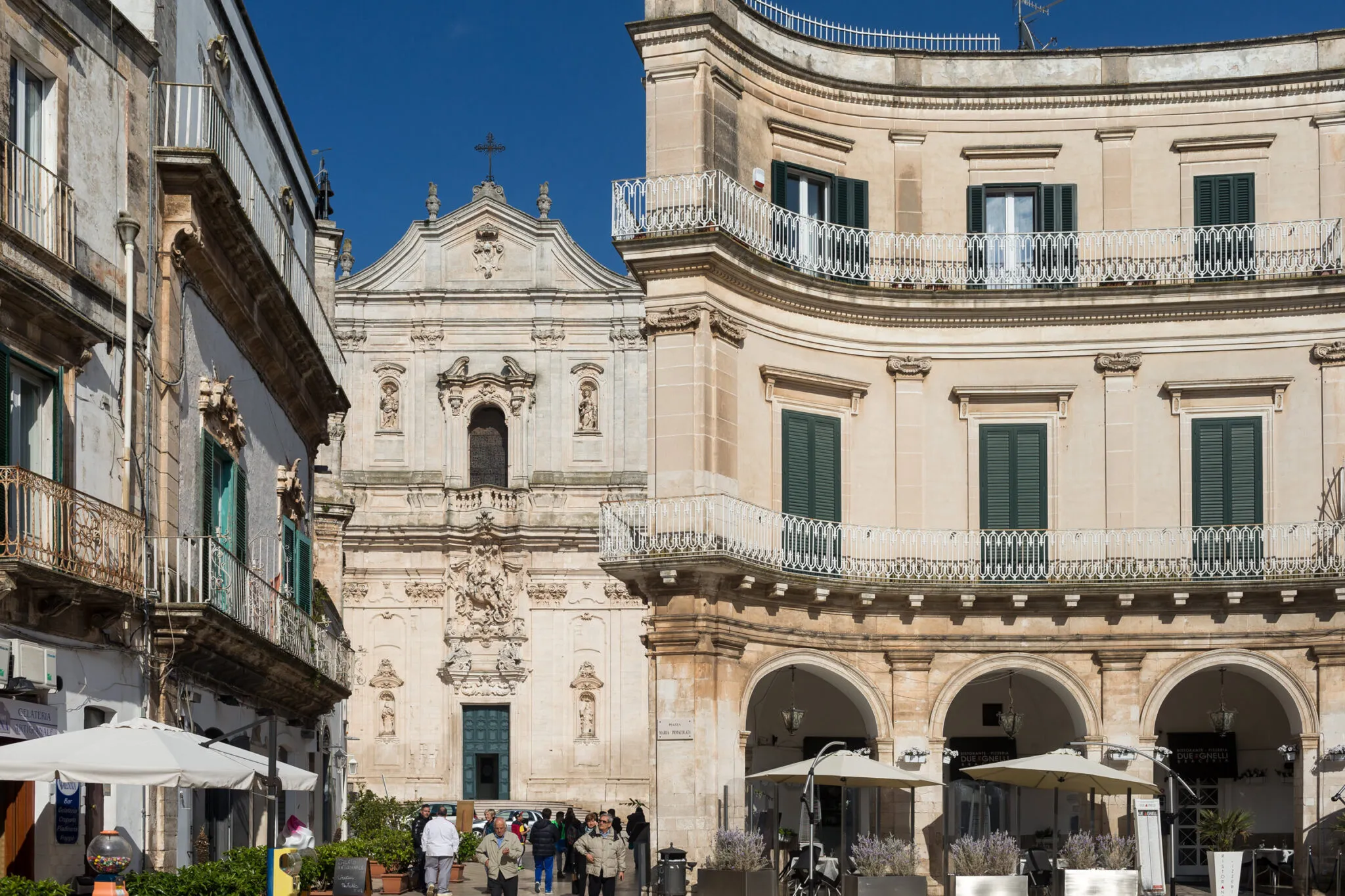 Curved building with a church in the background