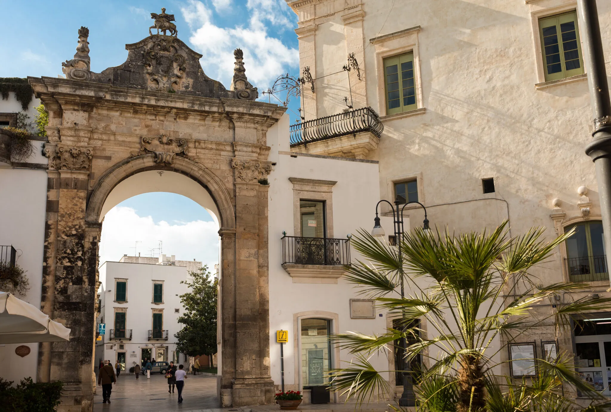 Buildings surrounding a courtyard with a stone archway