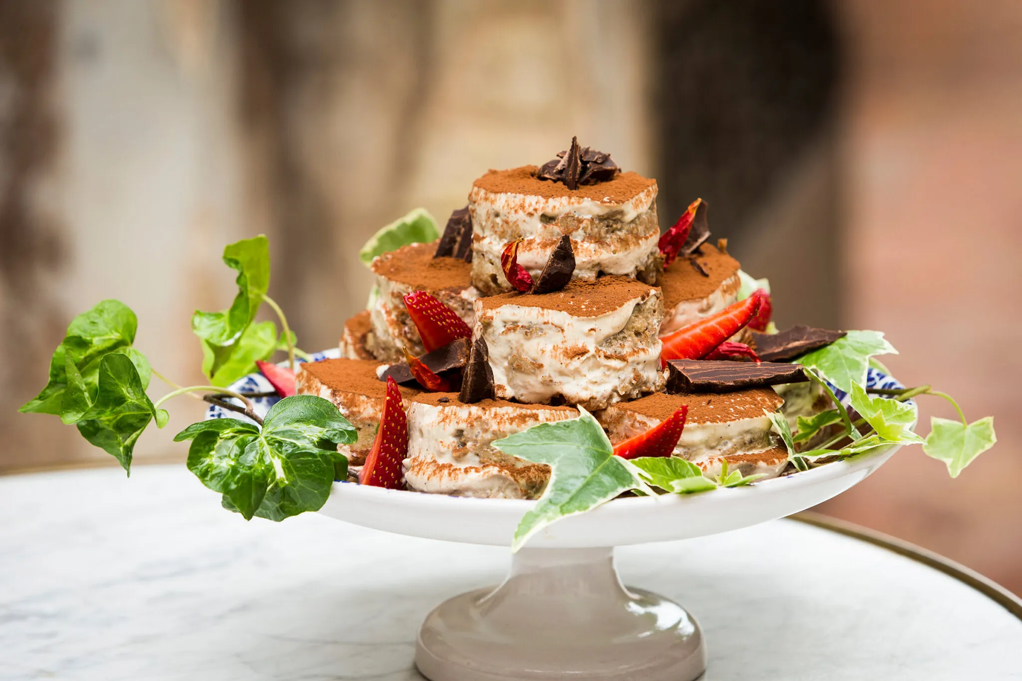 A platter with a stack of tiramisu slices