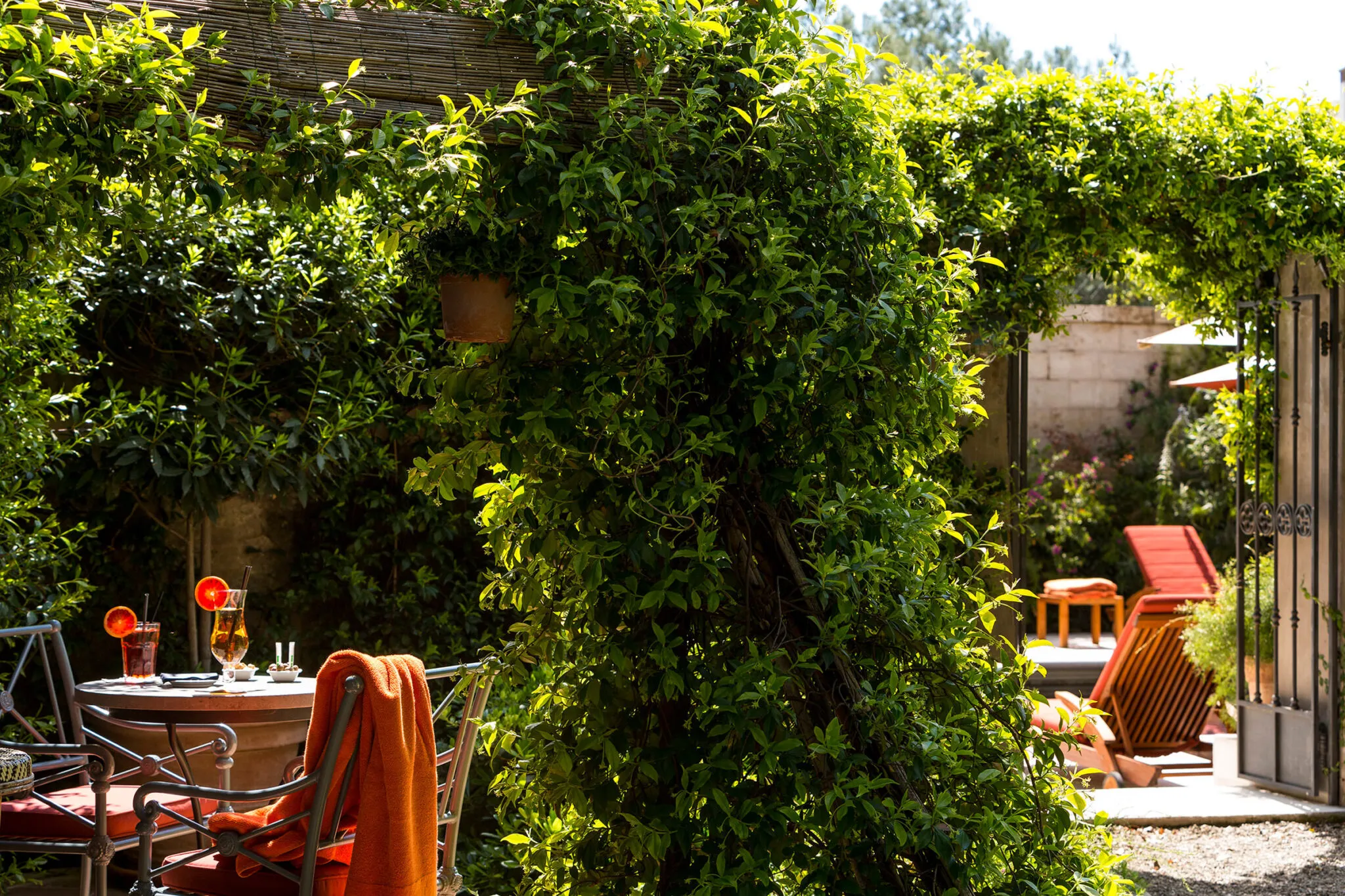 A towel draped over a dining chair in the pool bar garden