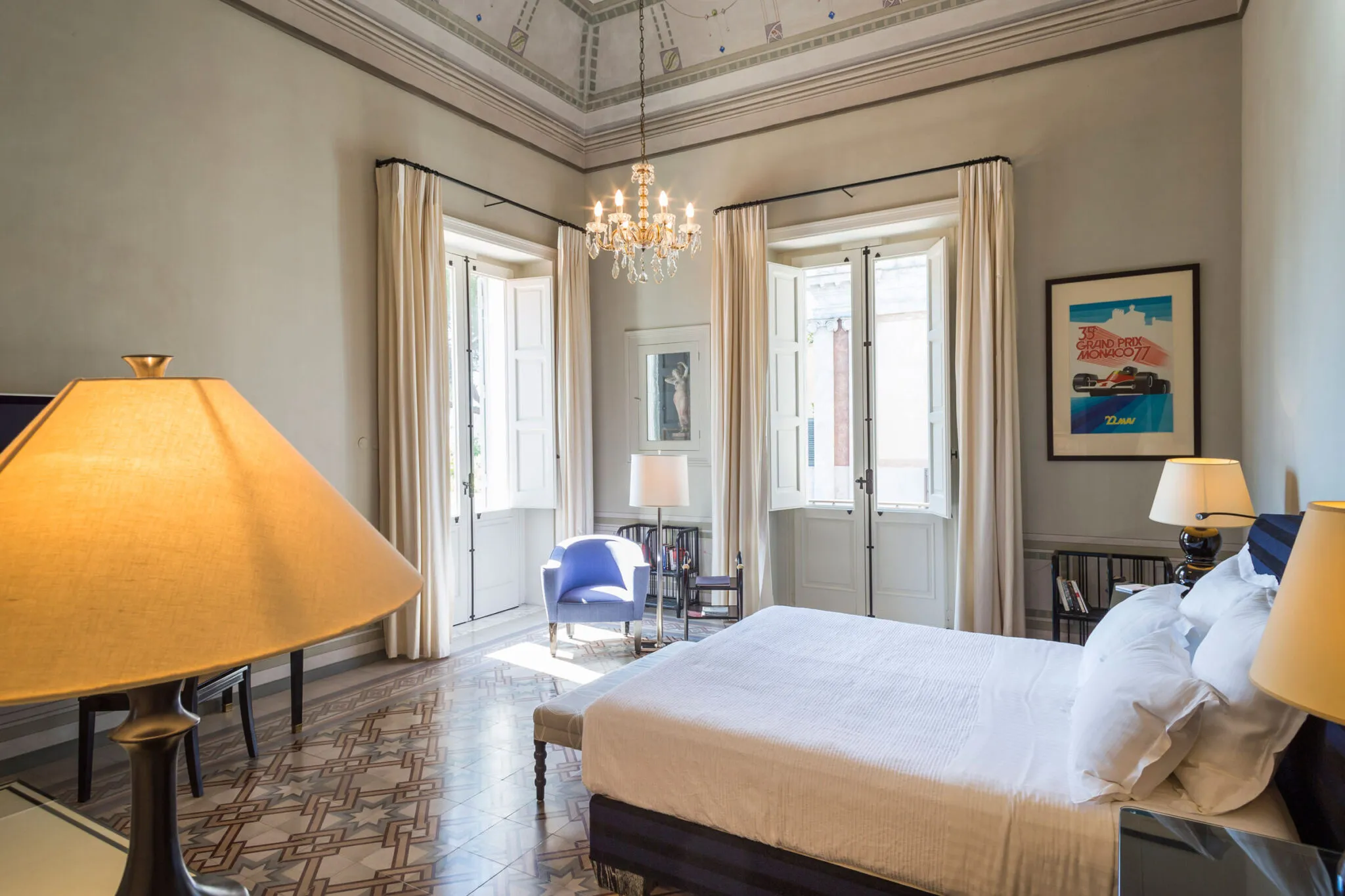 Bedroom with double bed and two sets of french doors