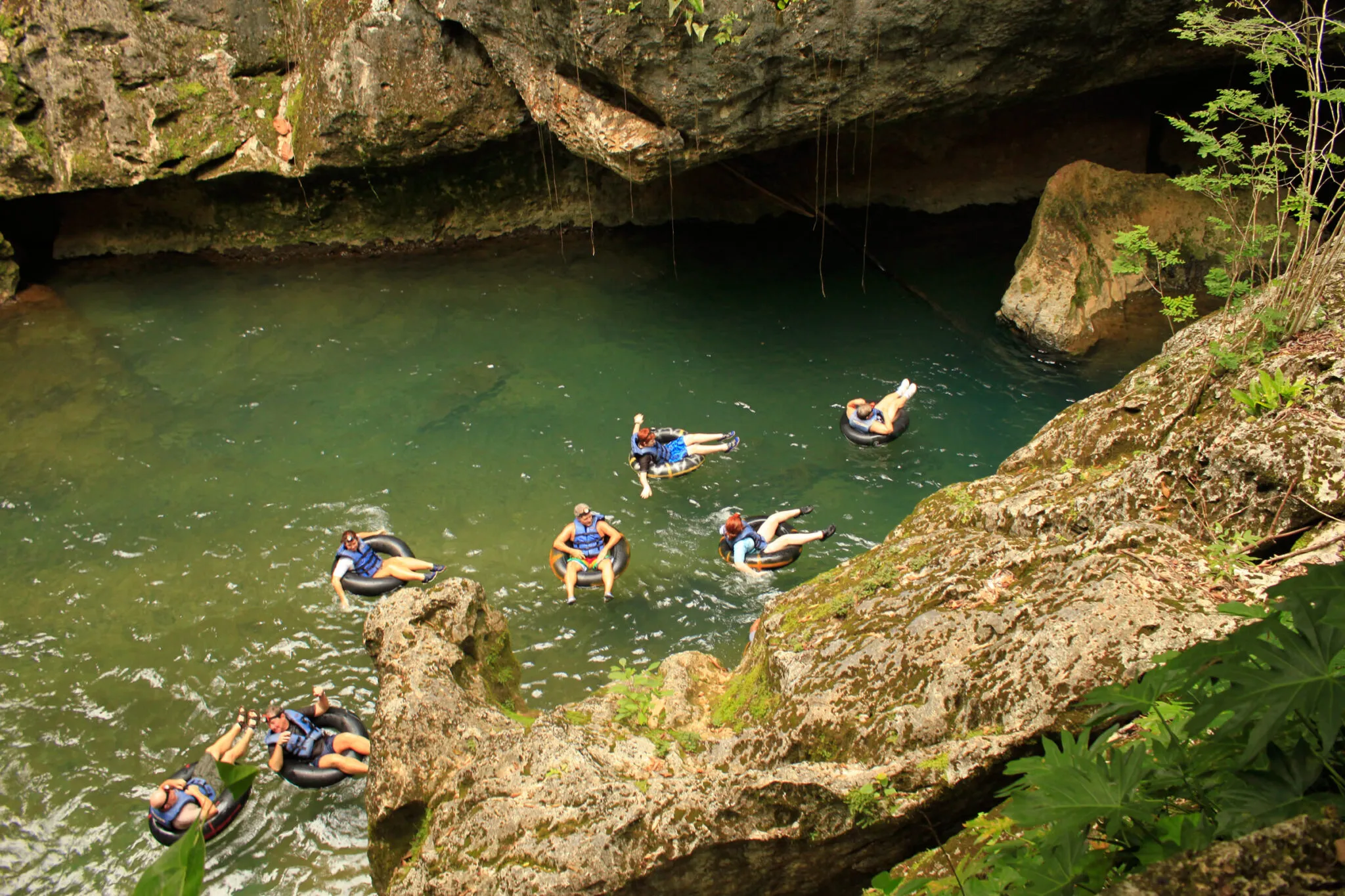 People floating in inner tubes seen from above