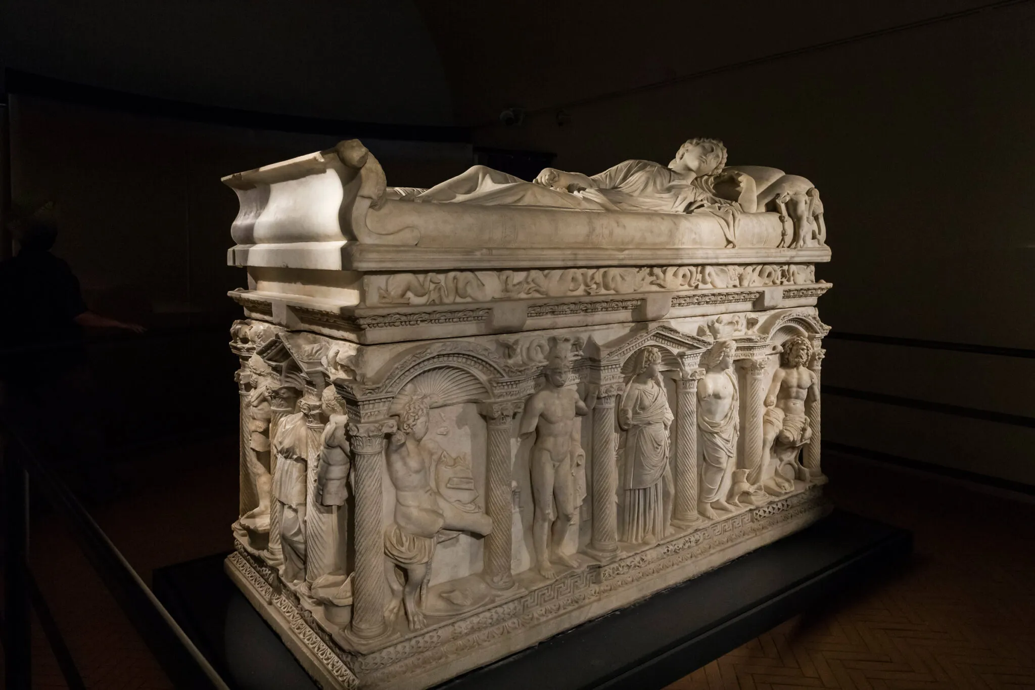 Side view of carved stone sarcophagus