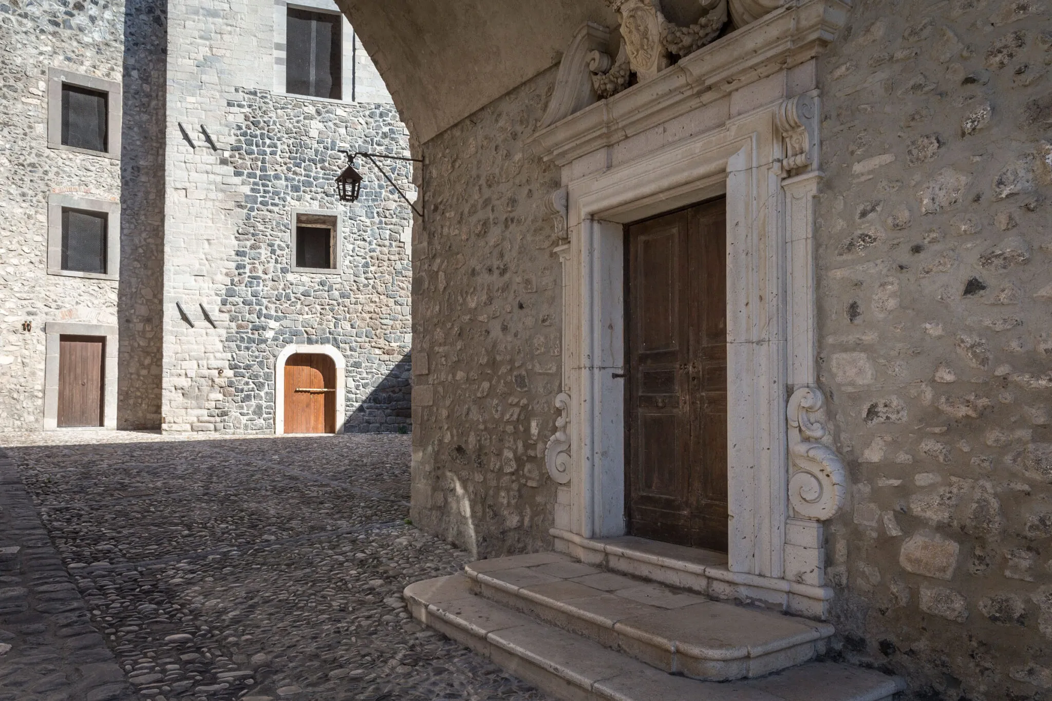 A brown doorway on a stone building in Melfi