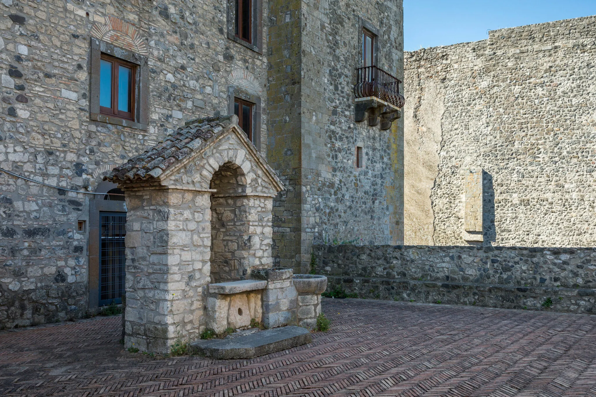 A courtyard surrounded by stone and brick buildings