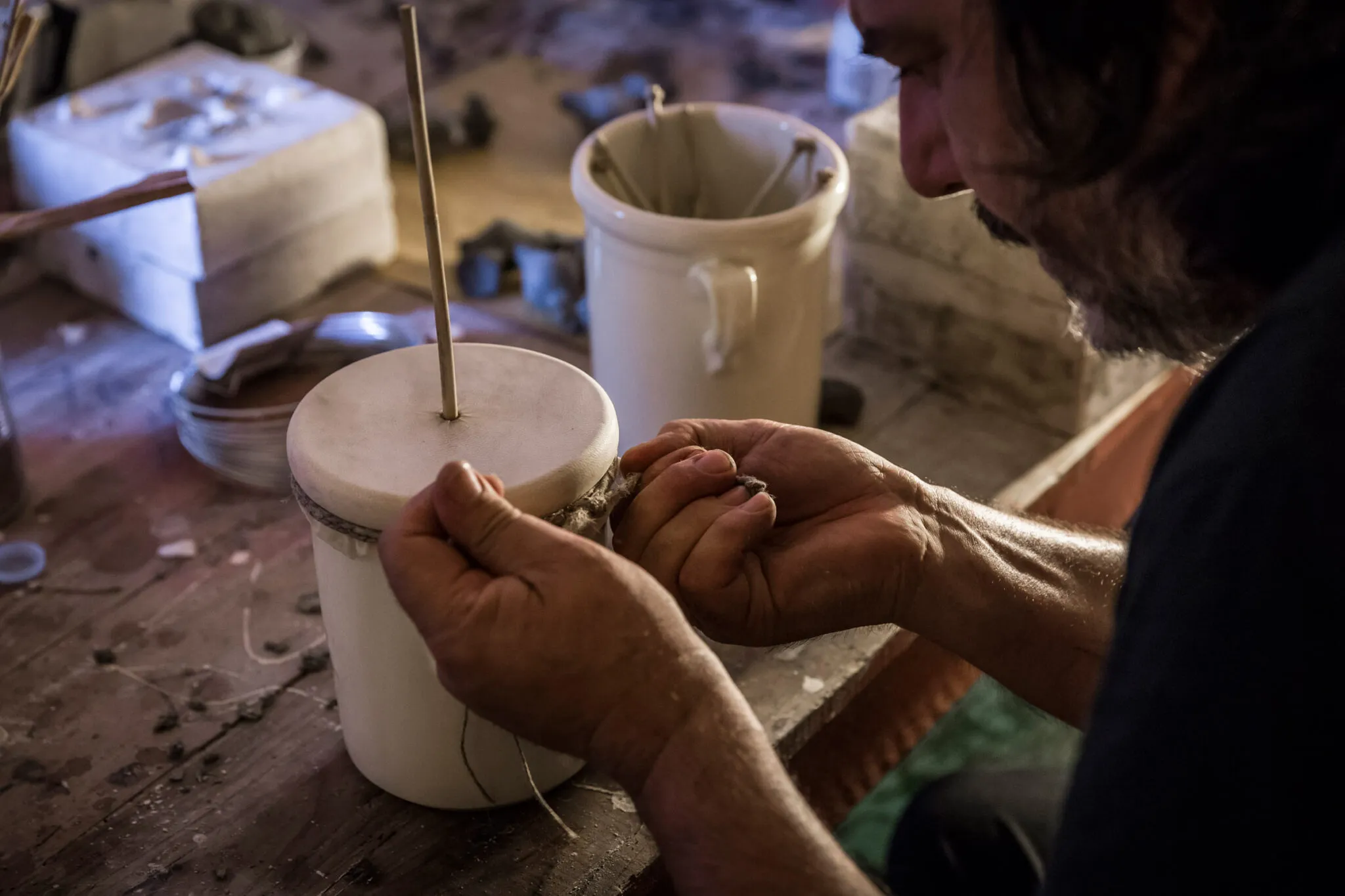 closeup of an artisan making an instrument