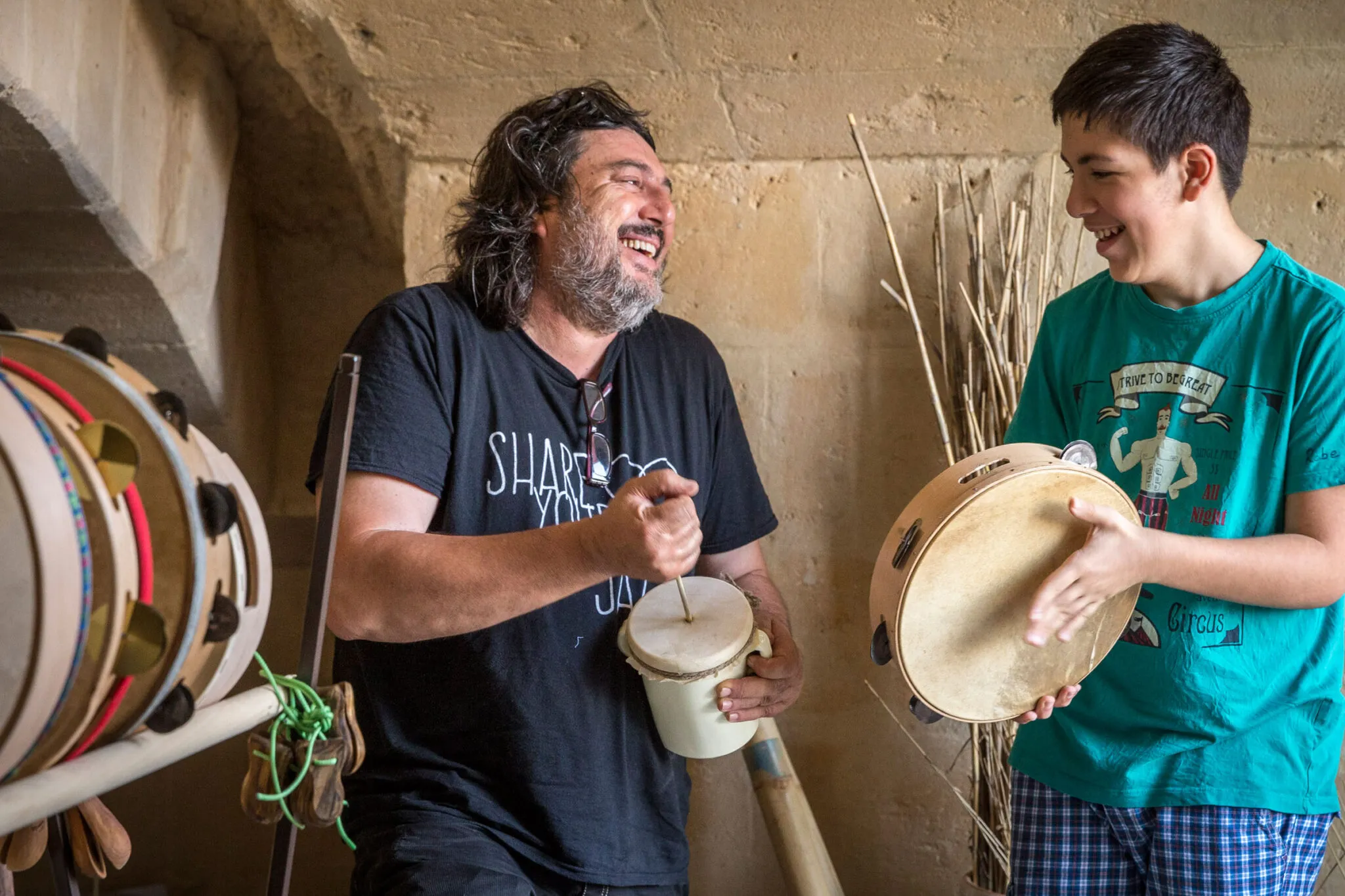 Two men playing folkloric instruments