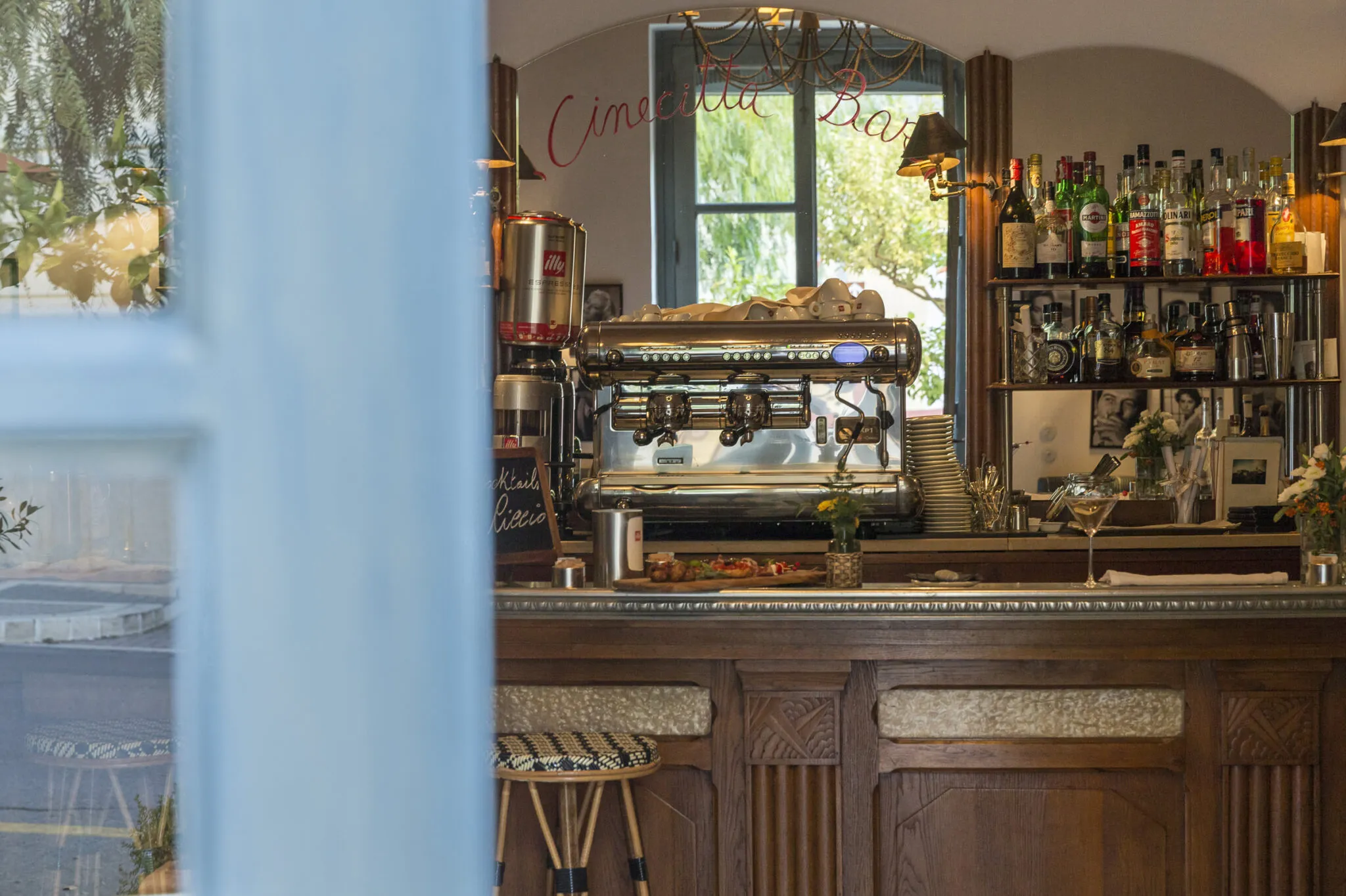 Close up of the bar with liquor bottles and espresso machine