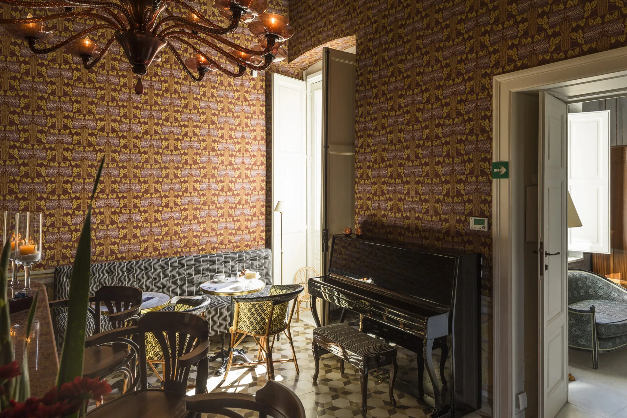 Bar tables and chairs near a piano