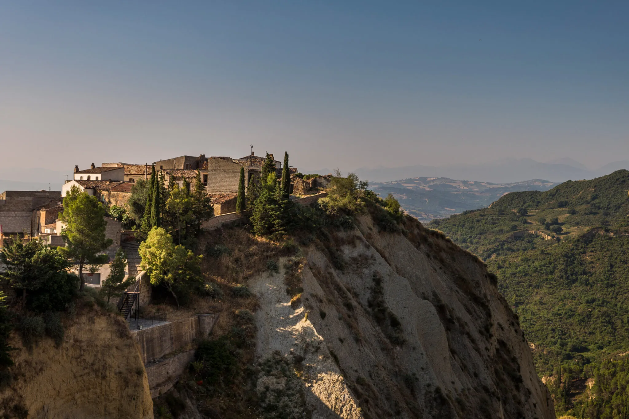 brick buildings atop a hill at Aliano