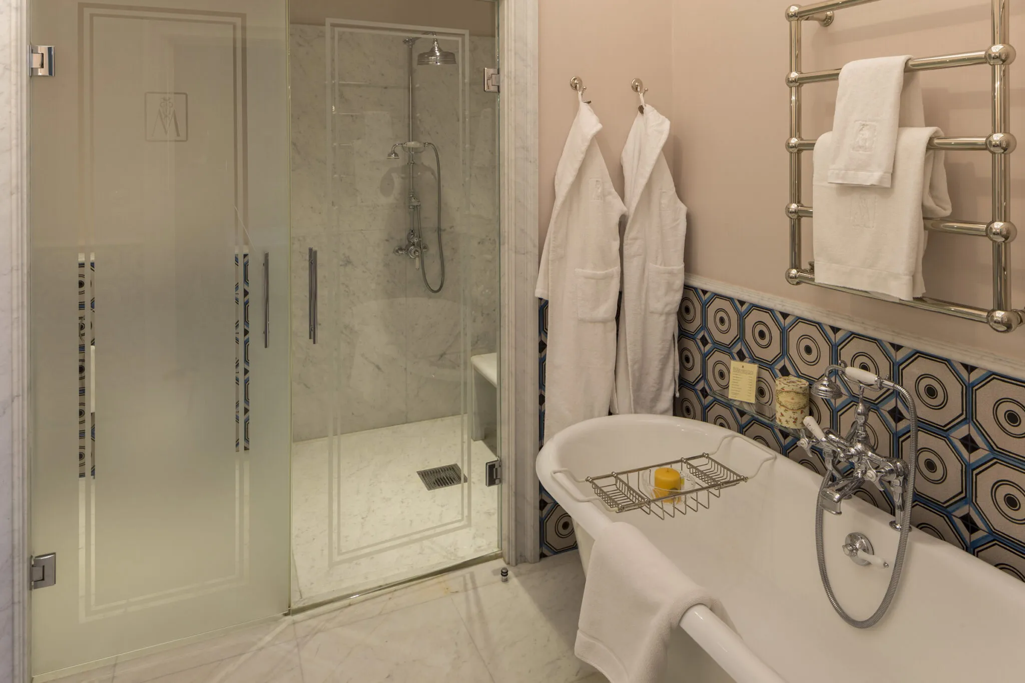 Bathroom with clawfoot bathtub and glass shower