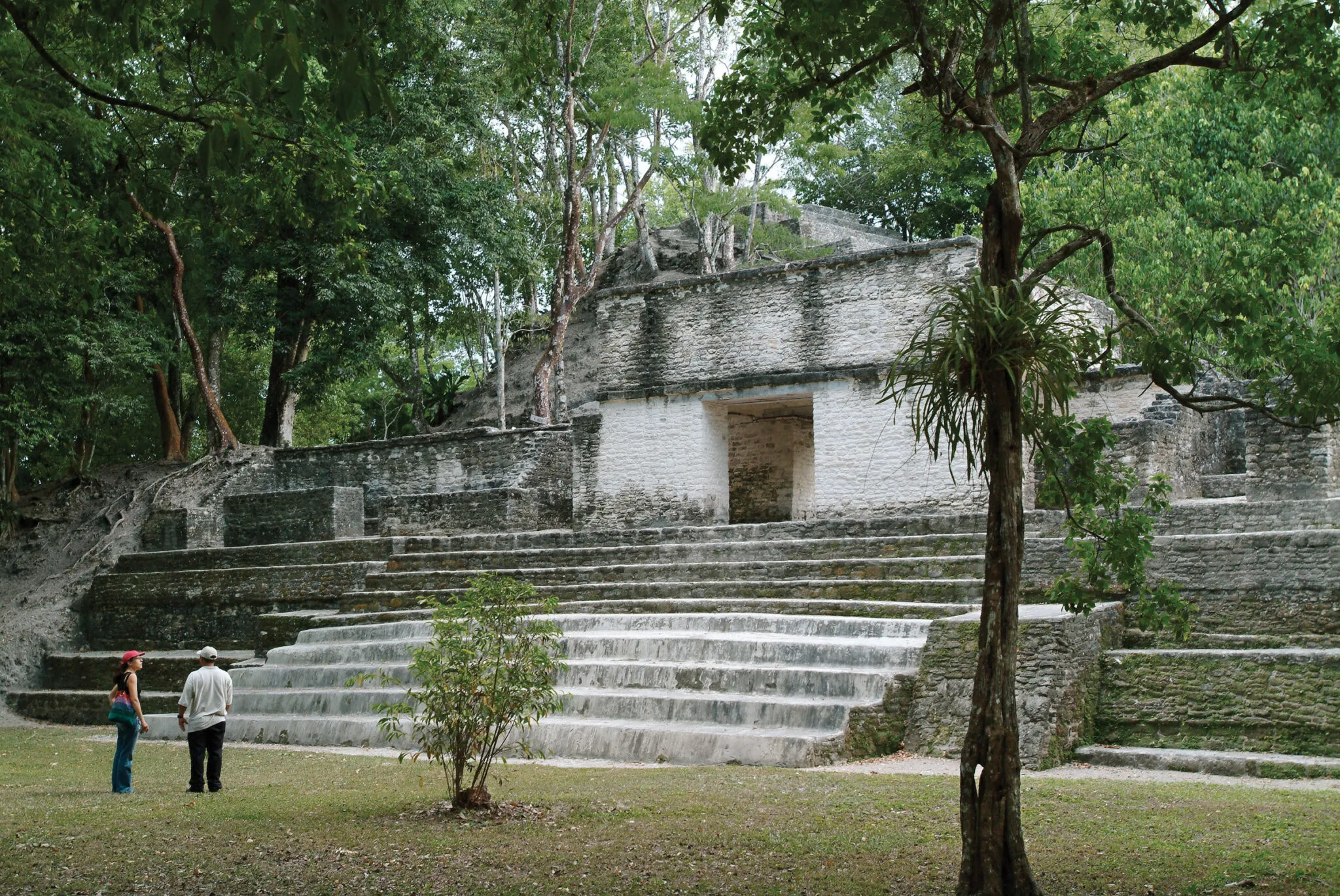 People standing at the base of an ancient pyramid