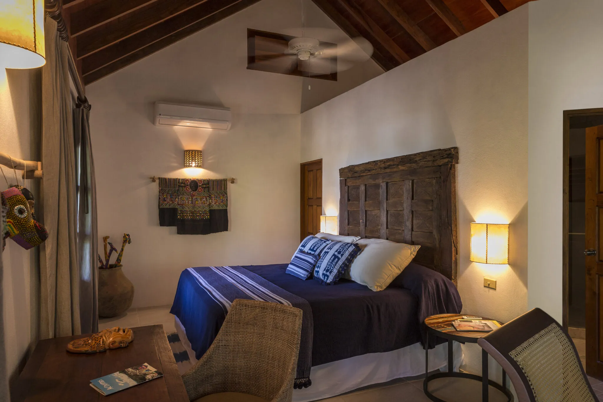 An overview of the Rainforest Junior Suite's interior, showing the bold blue bedding..