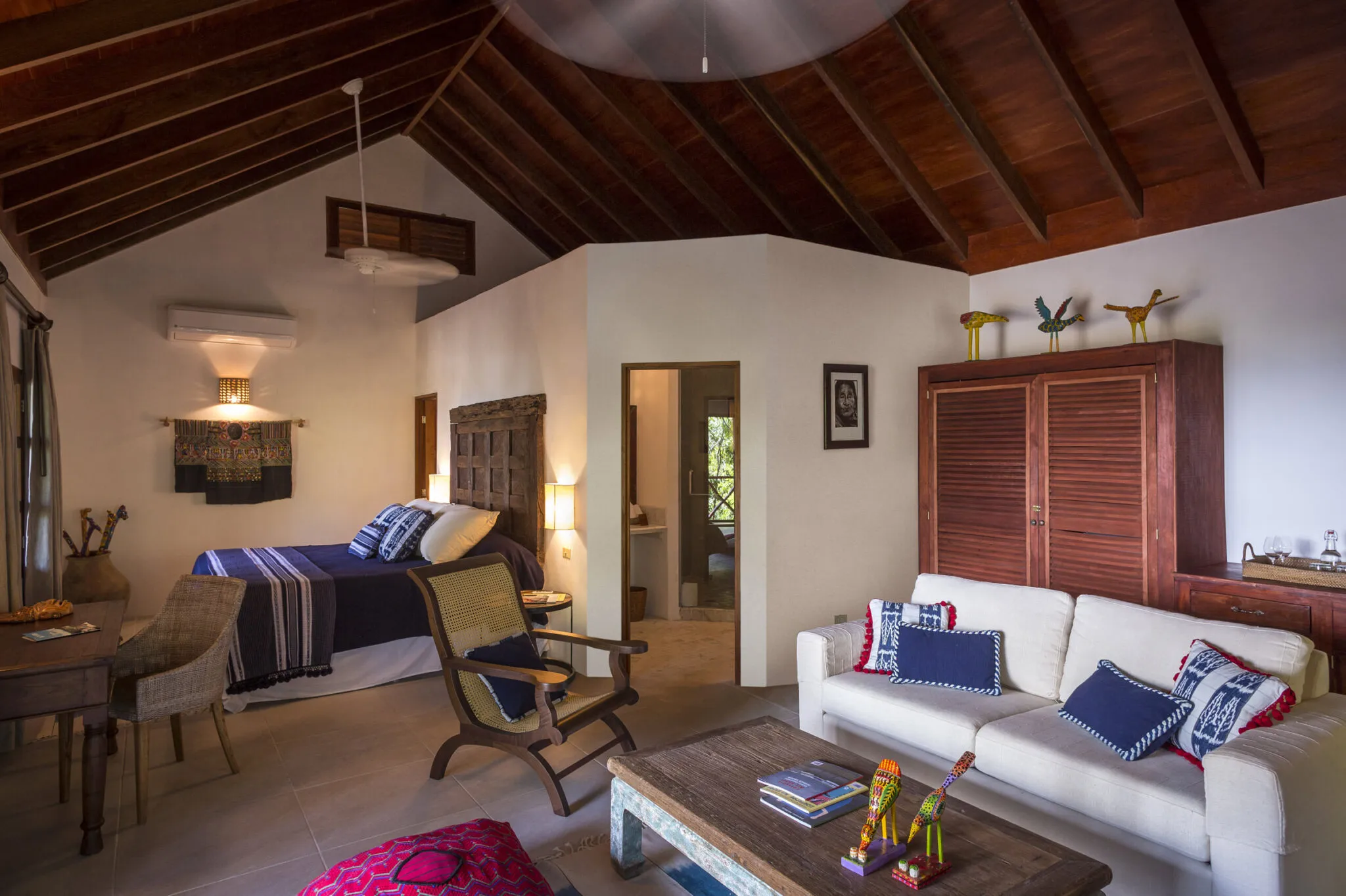 An overview of the Rainforest Junior Suite's interior, from the living space to the bed.