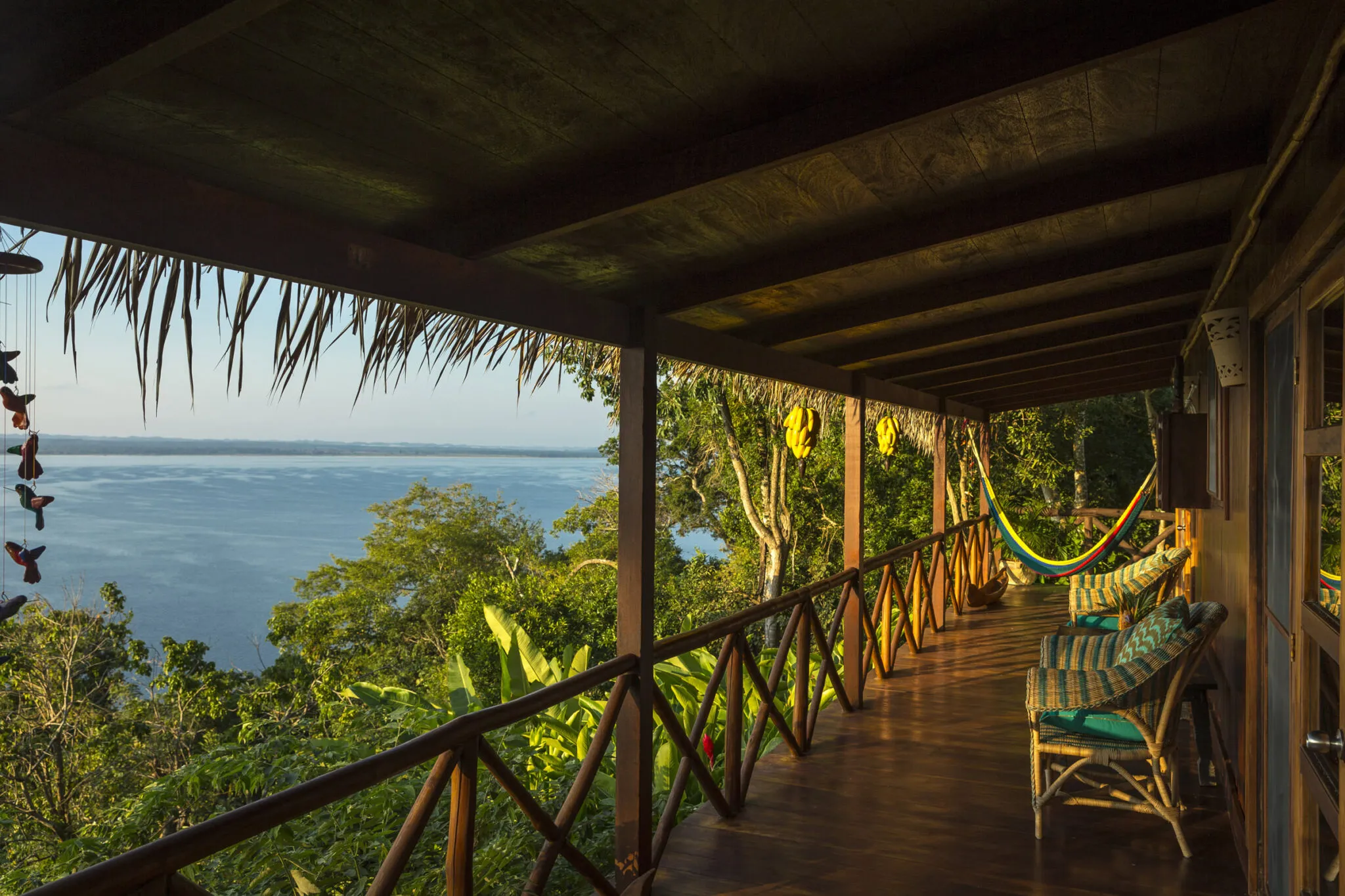 An outdoor deck of the Lakeview Suite, with outdoor chairs and a hammock.