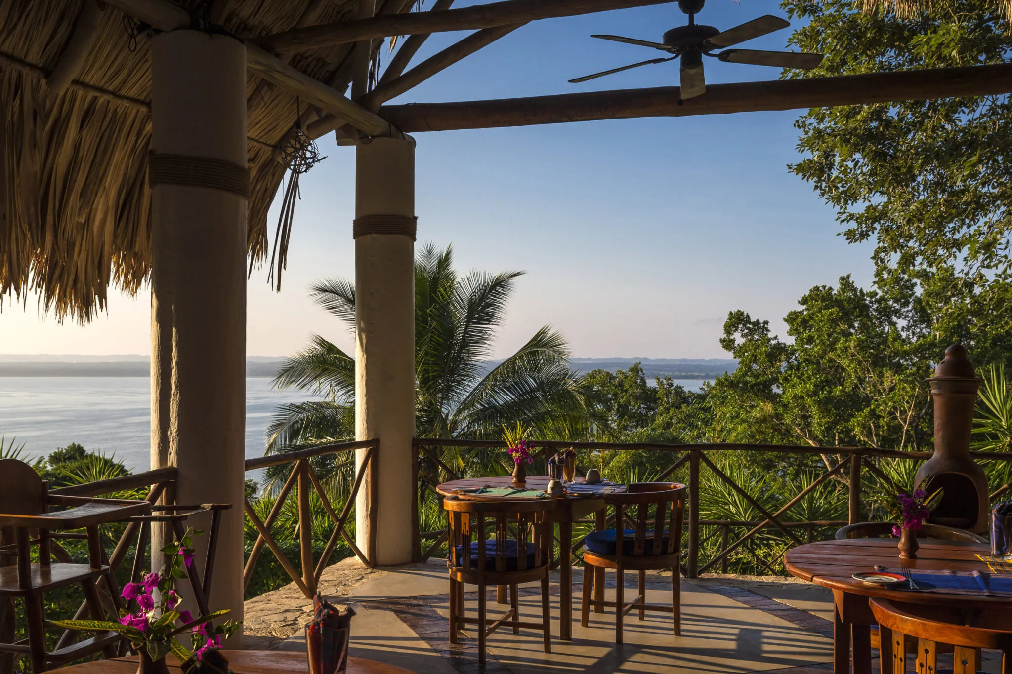 A corner of the La Lancha restaurant at sunset with a view of the water.