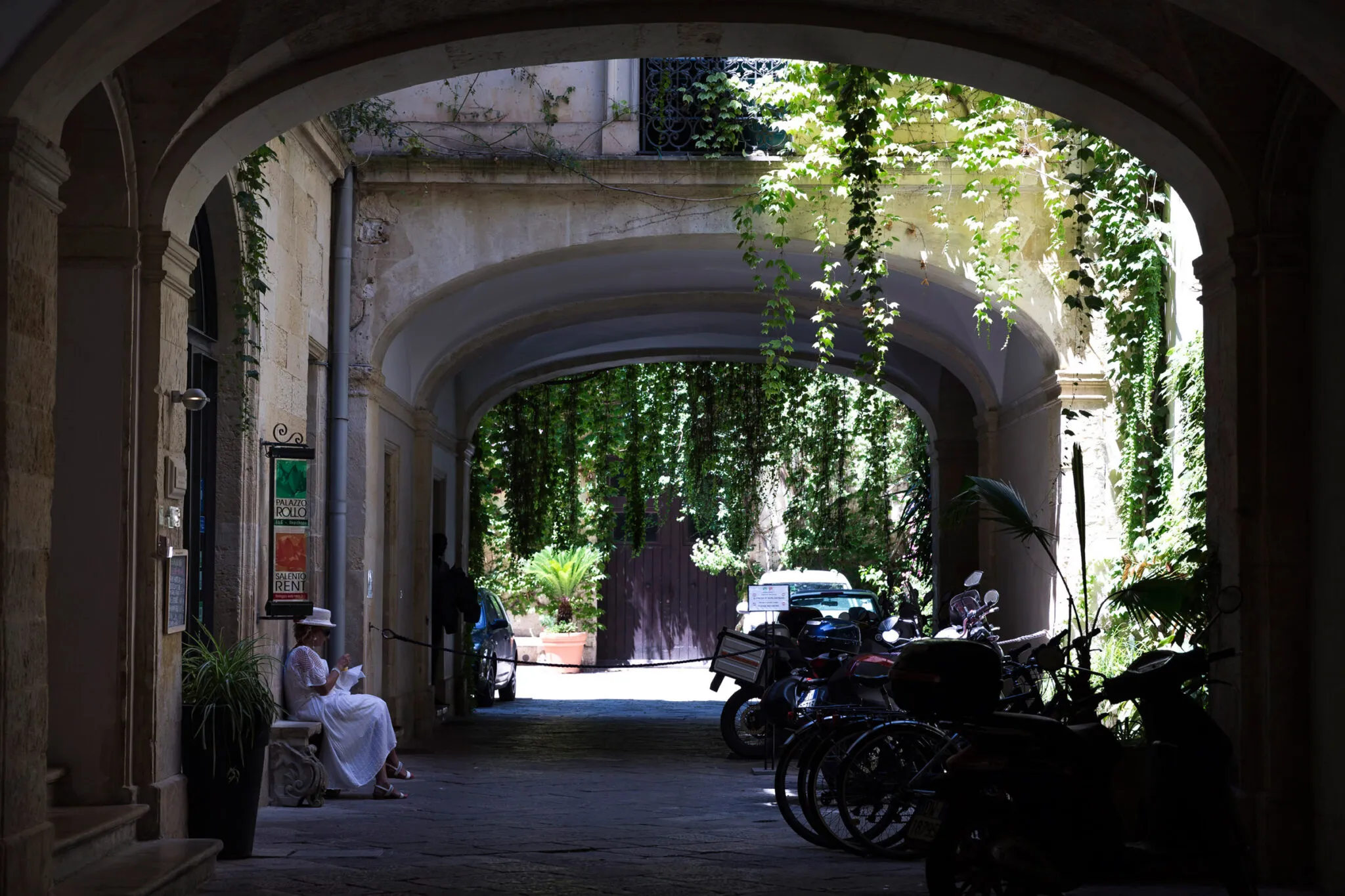 Motorbikes parked on a shady street