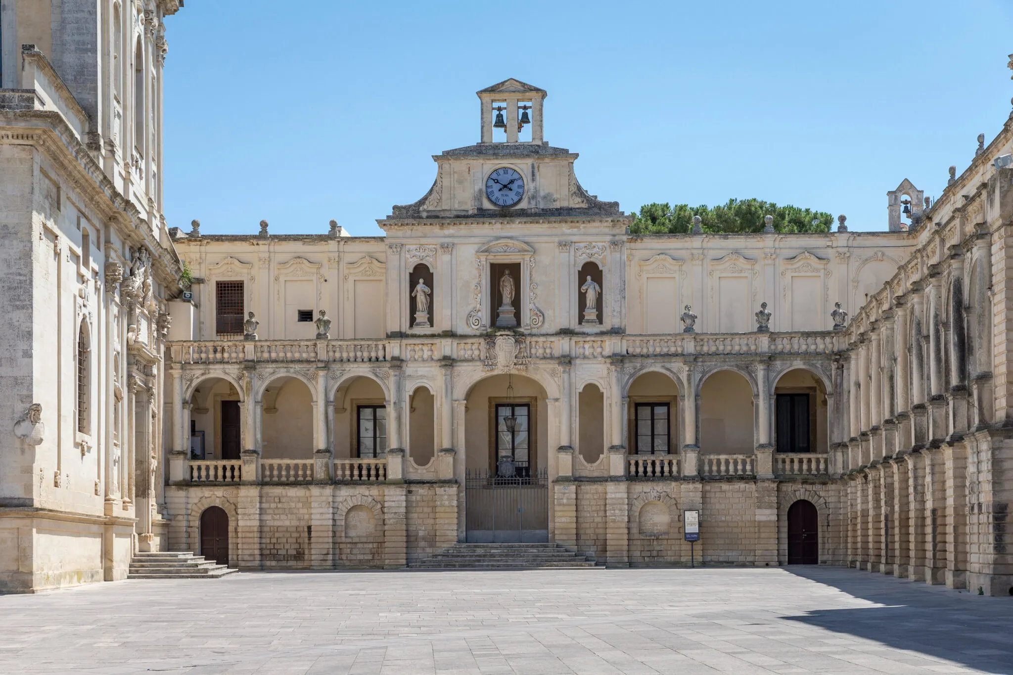 Building exterior with three statues and a clock tower