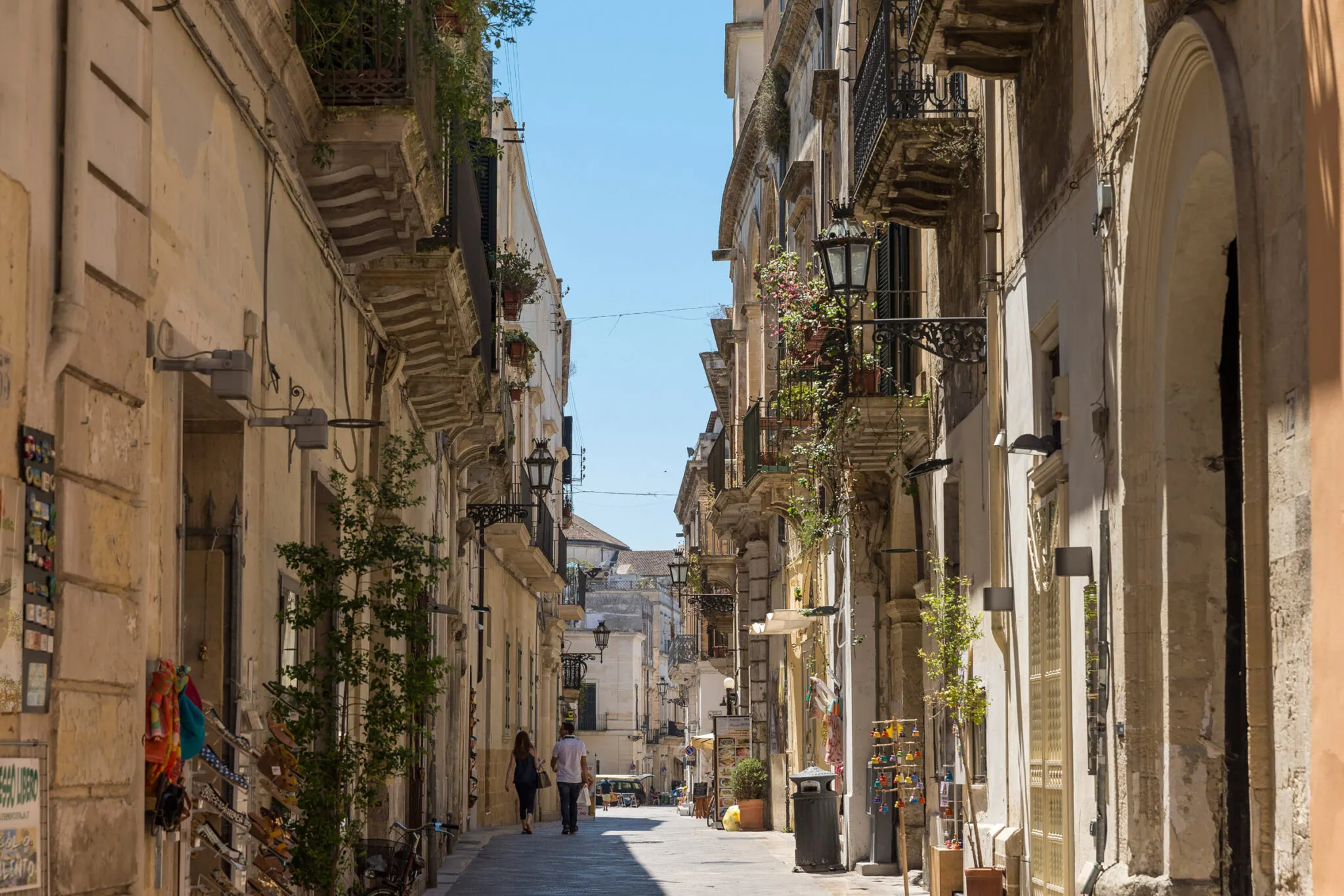 A narrow street between buildings with balconies