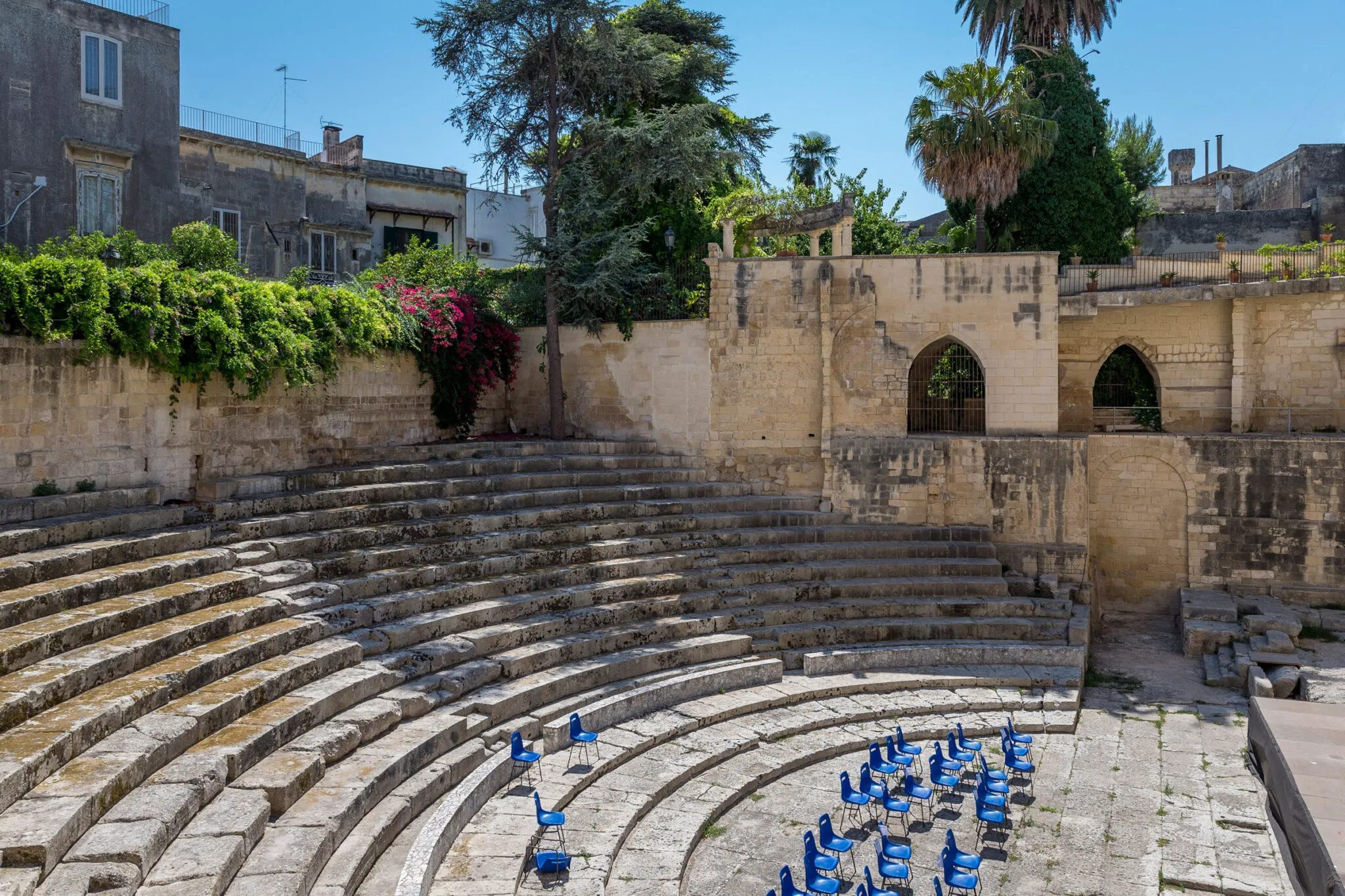 Outdoor amphitheater with blue chairs and stone risers