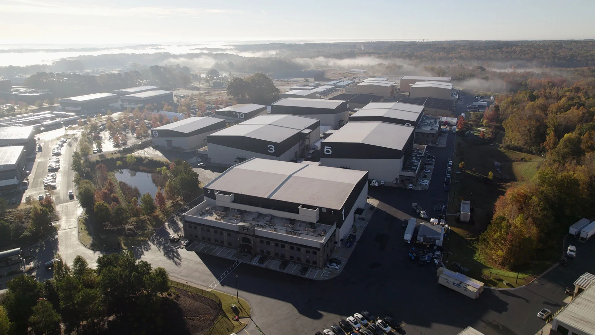 An aerial view of the exteriors of large movie studio buildings.