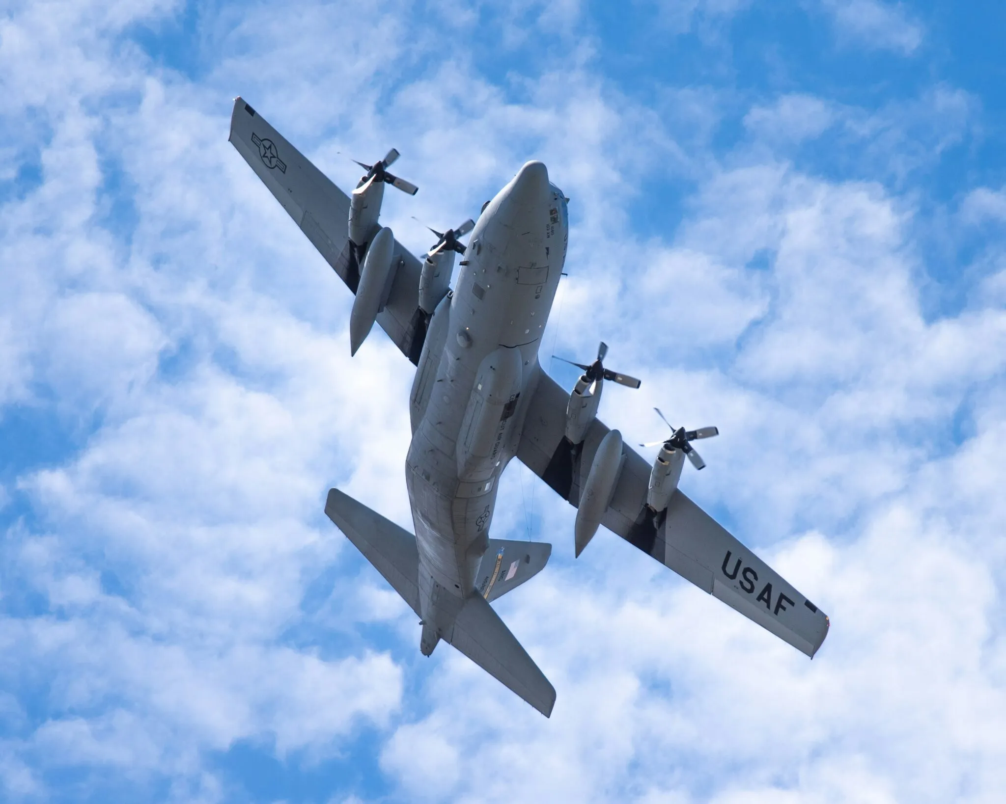 The underside of a vintage military plane in flight